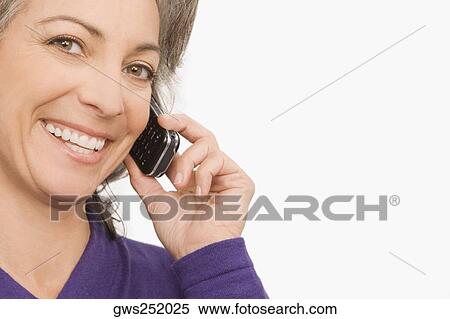 Stock Photography - Portrait of a businesswoman talking on a mobile phone. Fotosearch