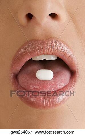 Close-up of a pill on a young woman's tongue View Large Photo Image Stock Photo - Close-up of a pill on a young woman's tongue. Fotosearch