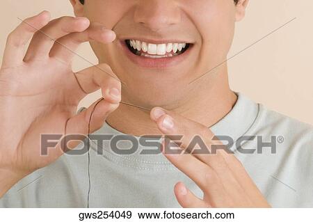 Close-up of a young man pinching a needle in his finger View Large Photo Image Stock Photo - Close-up of a young man pinching a needle in his finger. Fotosearch