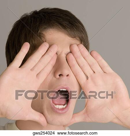 Close-up of a young man shouting View Large Photo Image Picture - Close-up of a young man shouting. Fotosearch