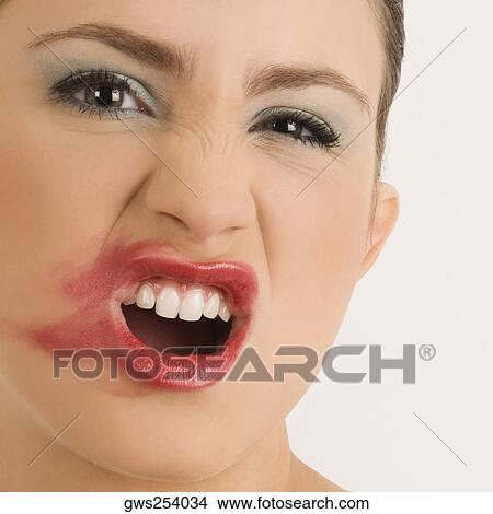 Picture - Portrait of a young woman with her messy lips. Fotosearch