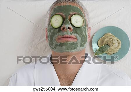 Close-up of a mature man lying down with a face pack and cucumber slices on her eyes View Large Photo Image Picture - Close-up of a mature man lying down with a face pack and cucumber slices on her eyes. Fotosearch