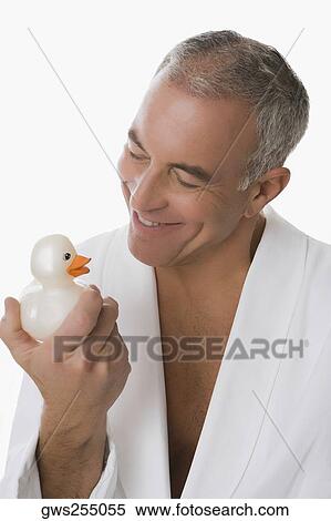 Close-up of a senior man holding a toy duck and smiling View Large Photo Image Stock Photography - Close-up of a senior man holding a toy duck and smiling. Fotosearch