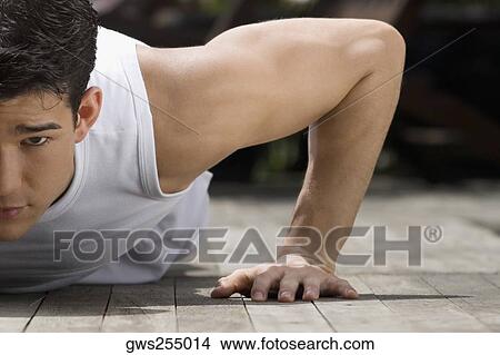 Close-up of a young man doing push-ups View Large Photo Image Picture - Close-up of a young man doing push-ups. Fotosearch
