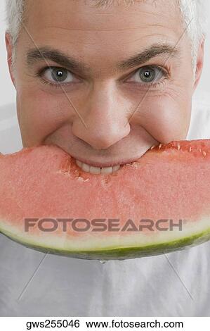 Portrait of a mature man eating a slice of watermelon View Large Photo Image Stock Photograph - Portrait of a mature man eating a slice of watermelon. Fotosearch