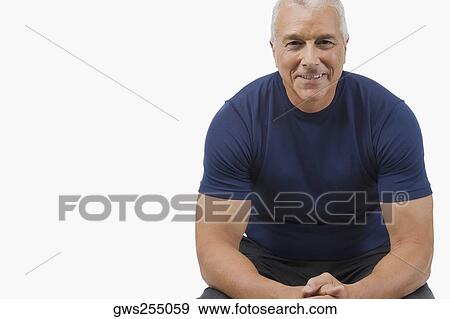 Portrait of a senior man sitting with his hands clasped and smiling View Large Photo Image Stock Photo - Portrait of a senior man sitting with his hands clasped and smiling. Fotosearch