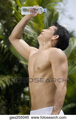 Side profile of a young man pouring water on his face View Large Photo Image Stock Image - Side profile of a young man pouring water on his face. Fotosearch