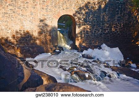 Stock Image - Polluted water spilling from an arch, Arcos Del Padre Tembleque, Tepeyahualco, Hidalgo, Mexico. Fotosearch