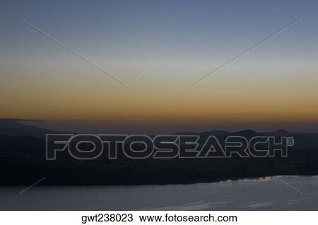 Silhouette of an island at dusk, Janitzio Island, Lake Patzcuaro, Morelia, Michoacan State, Mexico View Large Photo Image Stock Image - Silhouette of an island at dusk, Janitzio Island, Lake Patzcuaro, Morelia, Michoacan State, Mexico. Fotosearch