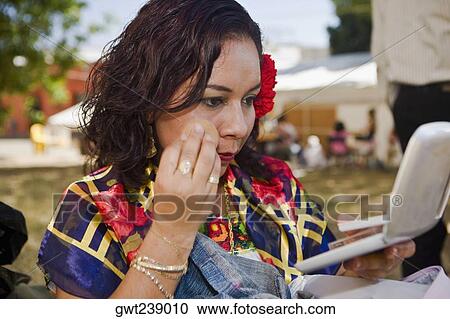 Stock Image - Close-up of a female dancer applying face powder, Oaxaca, Oxaca State, Mexico. Fotosearch