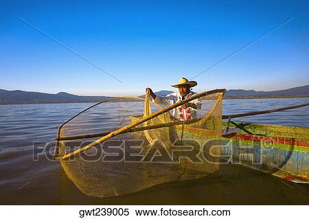 Fisherman with butterfly fishing net in a lake, Janitzio Island, Lake Patzcuaro, Patzcuaro, Michoacan State, Mexico View Large Photo Image Stock Photography - Fisherman with butterfly fishing net in a lake, Janitzio Island, Lake Patzcuaro, Patzcuaro, Michoacan State, Mexico. Fotosearch