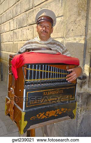 Portrait of a mature man holding a harmonipan, Mexico City, Mexico View Large Photo Image Stock Image - Portrait of a mature man holding a harmonipan, Mexico City, Mexico. Fotosearch