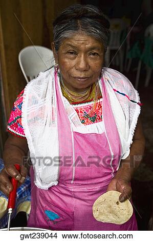 Picture - Portrait of a senior woman holding tortilla and cooking, Cuetzalan, Puebla State, Mexico. Fotosearch