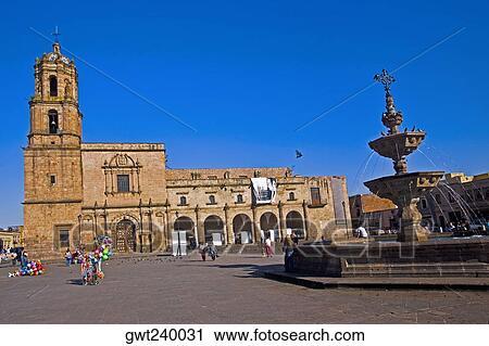 Stock Image - Group of people in front of a church, Church of San Francisco, convent of San Francisco, Plaza Valladolid, Morelia, Michoacan State, Mexico. Fotosearch