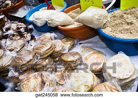 Stock Photo - High angle view of breads and spices at a market stall, Zacatecas State, Mexico. Fotosearch