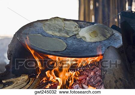 Stock Image - Tortilla preparing on the griddle, Santo Tomas Jalieza, Oaxaca State, Mexico. Fotosearch