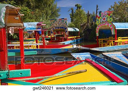 Trajineras boats in a canal, Xochimilco Gardens, Mexico City, Mexico View Large Photo Image Stock Image - Trajineras boats in a canal, Xochimilco Gardens, Mexico City, Mexico. Fotosearch