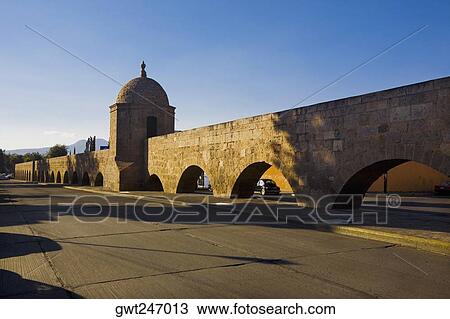 Stock Image - Aqueduct along a road, Morelia, Michoacan State, Mexico. Fotosearch