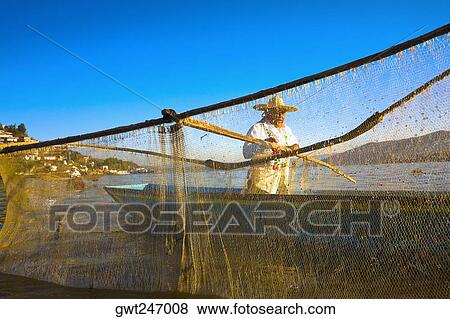 Fisherman with butterfly fishing net in a lake, Janitzio Island, Lake Patzcuaro, Patzcuaro, Michoacan State, Mexico View Large Photo Image Stock Photo - Fisherman with butterfly fishing net in a lake, Janitzio Island, Lake Patzcuaro, Patzcuaro, Michoacan State, Mexico. Fotosearch