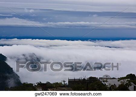 Stock Photo - High angle view of clouds on a hill, Cuetzalan, Puebla State, Mexico. Fotosearch