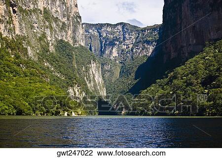 Stock Image - Panoramic view of a lake with a mountain range in the background, Sumidero Canyon, Chiapas, Mexico. Fotosearch