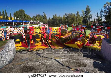 Trajineras boats moored in a canal, Xochimilco Gardens, Mexico City, Mexico View Large Photo Image Stock Photo - Trajineras boats moored in a canal, Xochimilco Gardens, Mexico City, Mexico. Fotosearch