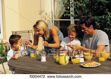 Stock Image - breakfast, woman, women, bowl of coffee, orange juice, smile, smiling. Fotosearch