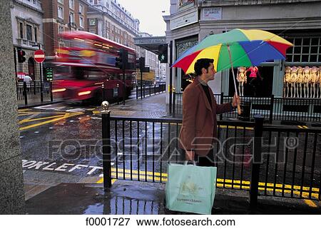 Stock Photo - bus, umbrella, rain, shopping, traffic, United Kingdom, England. Fotosearch