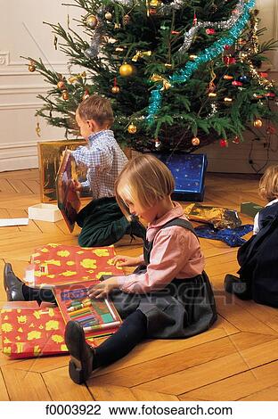 Stock Image - child, children, Christmas, Xmas, Christmas tree, gift, offer. Fotosearch