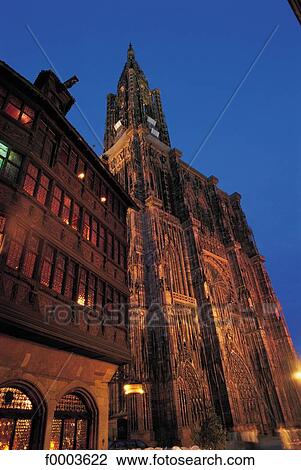 Stock Image - Christian architecture, cathedral, church, front, traditional dwelling, night, Alsace. Fotosearch