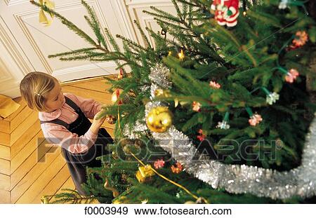 Stock Photo - Christmas tree, Christmas, Xmas, Christmas decoration, celebration, people, girl. Fotosearch
