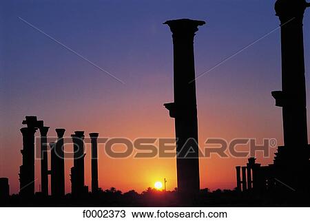 Stock Image - column, pillar, sunset, setting sun, vestige, ruin, antiquity. Fotosearch