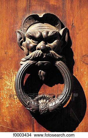 Picture - door handle, door knocker, metal, object, objects, face. Fotosearch