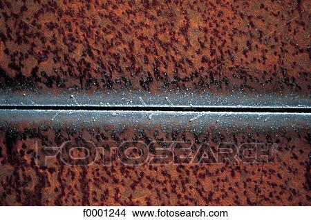 Picture - erosion, rust, rusty metal, beige, exterior, open air. Fotosearch
