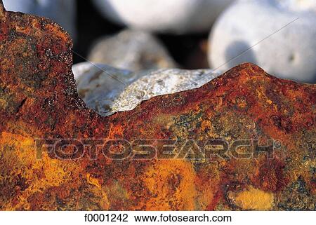 Stock Image - erosion, rust, rusty metal, orange, exterior, open air. Fotosearch