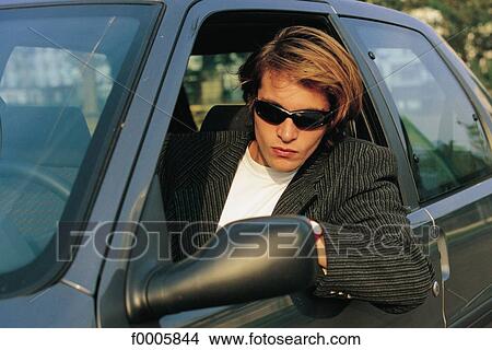 exterior, open air, teenage boy, car, rearview mirror, sunglasses, aware View Large Photo Image Picture - exterior, open air, teenage boy, car, rearview mirror, sunglasses, aware. Fotosearch