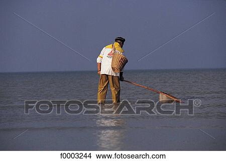 Picture - fisherman, sea, people, Calvados, Courseulles sur mer, Europe, France. Fotosearch
