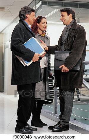 Stock Photo - going out of work, meeting, meet, colleague, joy, joyful, enthousiast. Fotosearch
