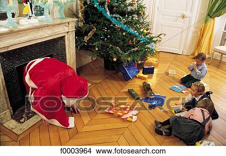 Picture - Santa Claus, Christmas, Xmas, child, children, fireplace, girl. Fotosearch