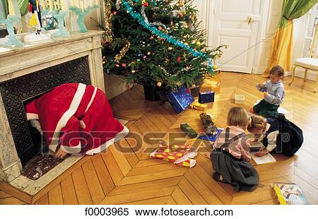 Santa Claus, fireplace, gift, offer, present, Christmas tree, Christmas decoration View Large Photo Image Stock Photography - Santa Claus, fireplace, gift, offer, present, Christmas tree, Christmas decoration. Fotosearch