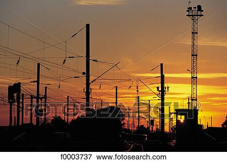 Stock Photo - sunset, setting sun, rail transport, pylon, Europe, France, French. Fotosearch