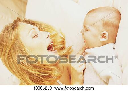 Stock Photo - woman, women, family, people, baby, tenderness, affection. Fotosearch