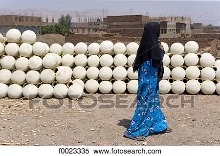 Egypt, between Qina and Luxor, near Maruza, potteries and woman View Large Photo Image Stock Photography - Egypt, between Qina and Luxor, near Maruza, potteries and woman. Fotosearch