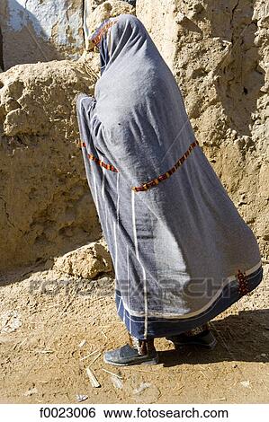 Egypt, Libyan desert, Siwa Oasis, woman wearing a traditional embroidered fabric View Large Photo Image Stock Photograph - Egypt, Libyan desert, Siwa Oasis, woman wearing a traditional embroidered fabric. Fotosearch