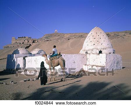 Picture - Egypt, near Aswan, camel rider passing in front of an old grave. Fotosearch