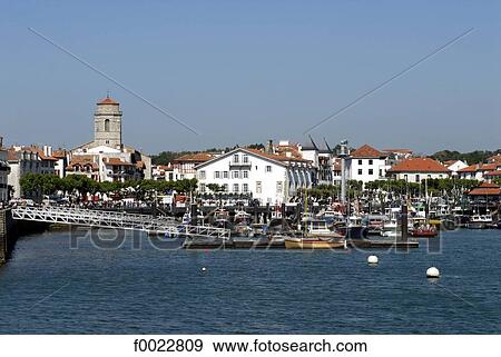 Stock Photo - France, Aquitaine, Saint Jean de Luz, harbour and Saint John the Baptist Church. Fotosearch
