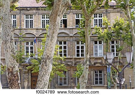 Stock Photo - France, Provence, Aix-en-Provence, building facade and plane trees. Fotosearch