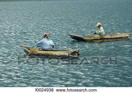 Guatemala, Santiago Atitlan, fishermen in dugout called "cayuco" View Large Photo Image Stock Photo - Guatemala, Santiago Atitlan, fishermen in dugout called "cayuco". Fotosearch