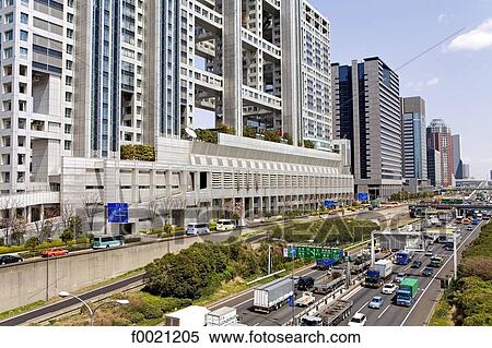 Stock Photography - Japan, Tokyo, Daiba quarter, road and modern buildings. Fotosearch