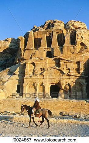Jordan, Petra, Nabataean tombs, bedouin riding horse View Large Photo Image Stock Photo - Jordan, Petra, Nabataean tombs, bedouin riding horse. Fotosearch